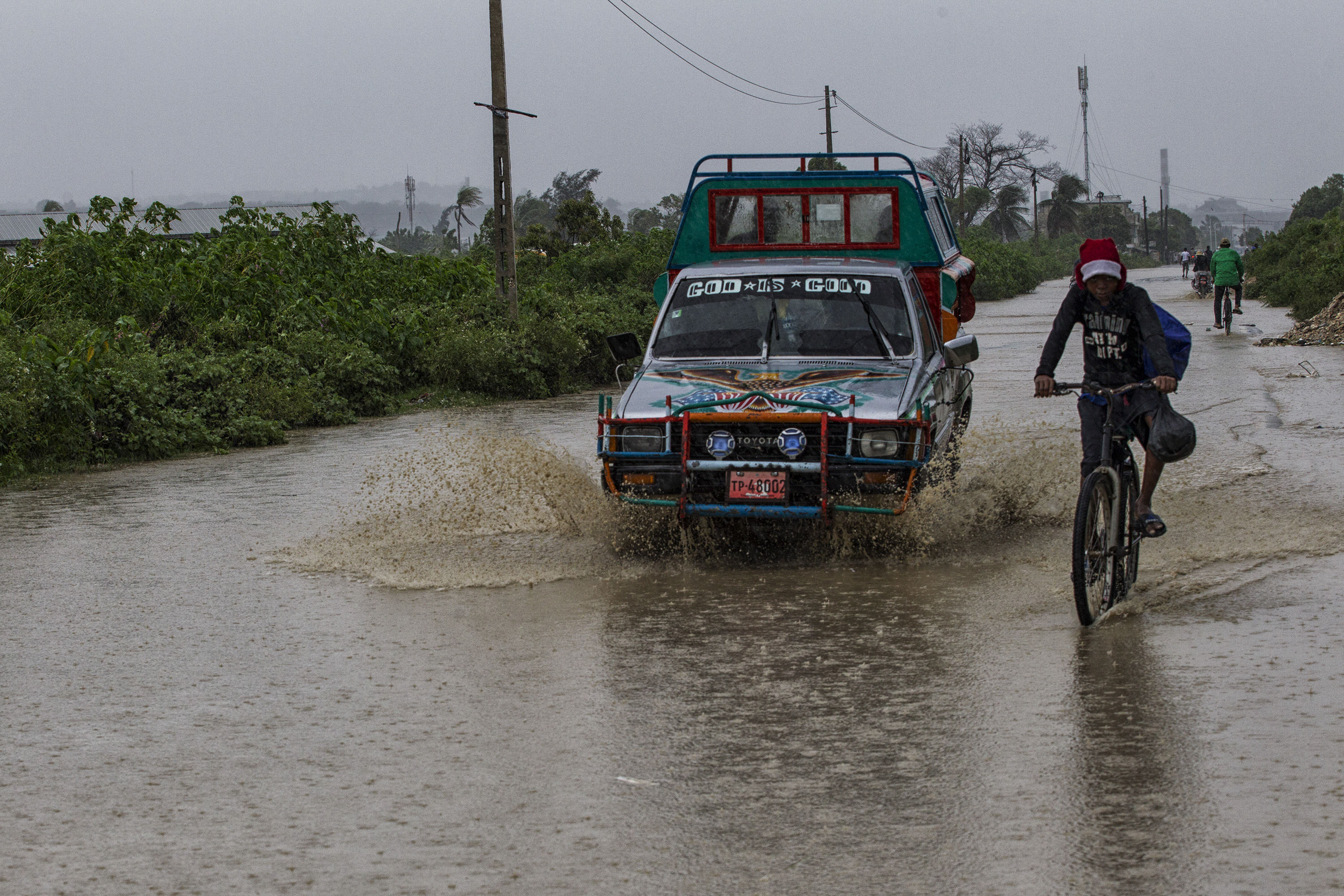 People make their way along a flooded road near Cite Soleil in Port au Prince. Hurricane Michael passed over Haiti today, with heavy rains and winds. While the capital Port au Prince was mostly spared from the full strength of the class 4 hurricane, the western cities of Les Cayes and Jeremie received the full force sustaining wind and water damage across wide areas. Photo Logan Abassi UN/MINUSTAH