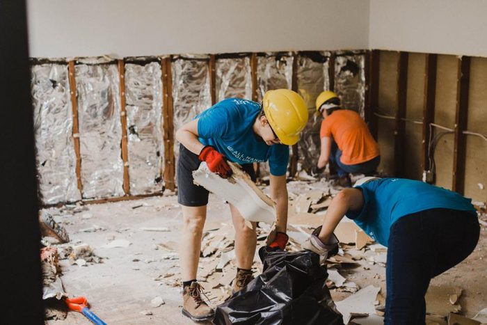 All Hands Volunteers remove flood-damaged drywall and wet insulation to prevent mold and harmful pathogens from developing within a Houston-area home. (Photo by All Hands Volunteers)