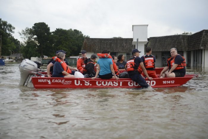 U.S. Coast Guard members rescue locals from flood water on their flat-bottom boats in Baton Rouge, Louisiana, Aug. 14, 2016. The Coast Guard sent water and air assets to assist the victims in the Baton Rouge area. (U.S. Coast Guard photo by Petty Officer 3rd Class Brandon Giles)