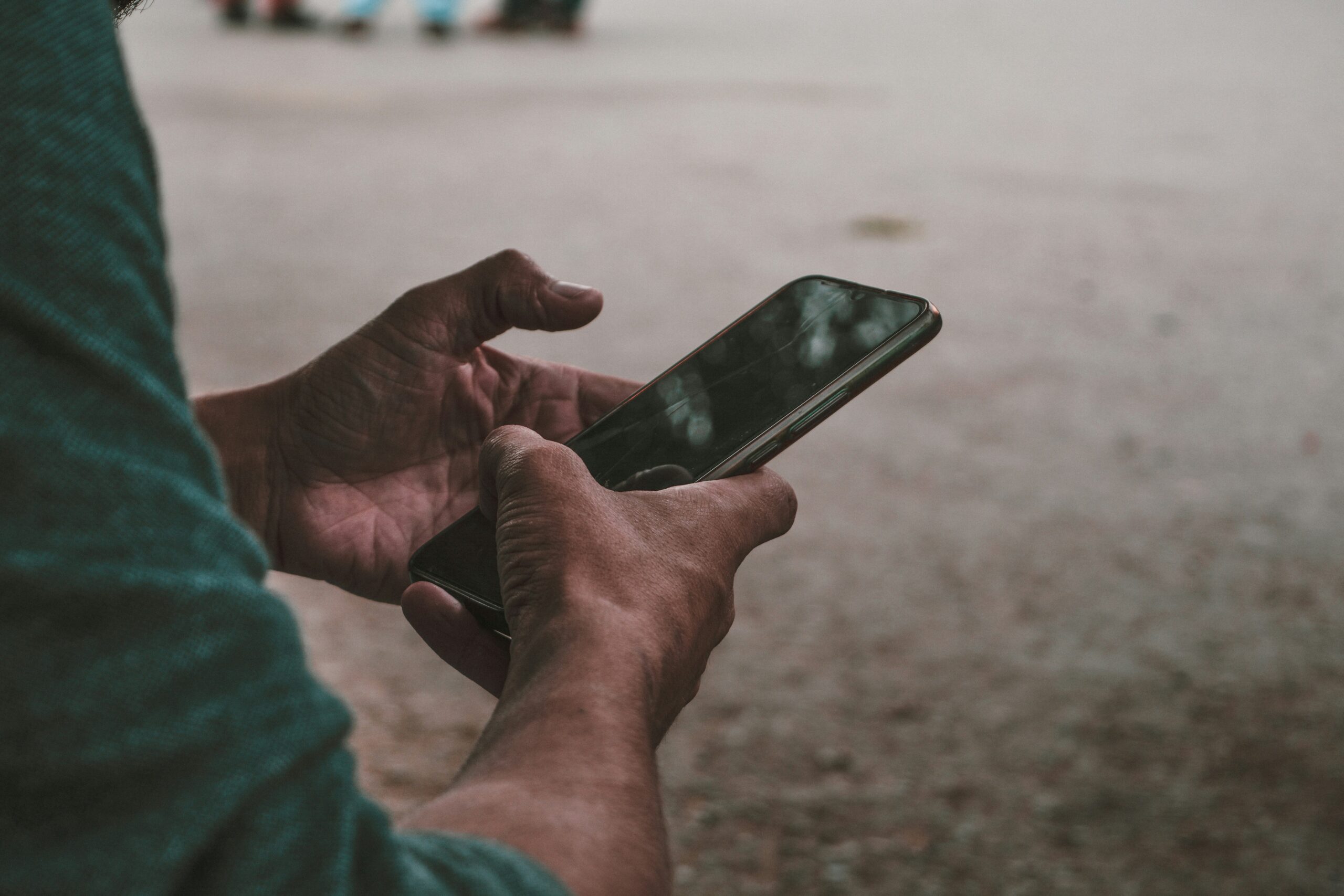 Hands holding cell phone